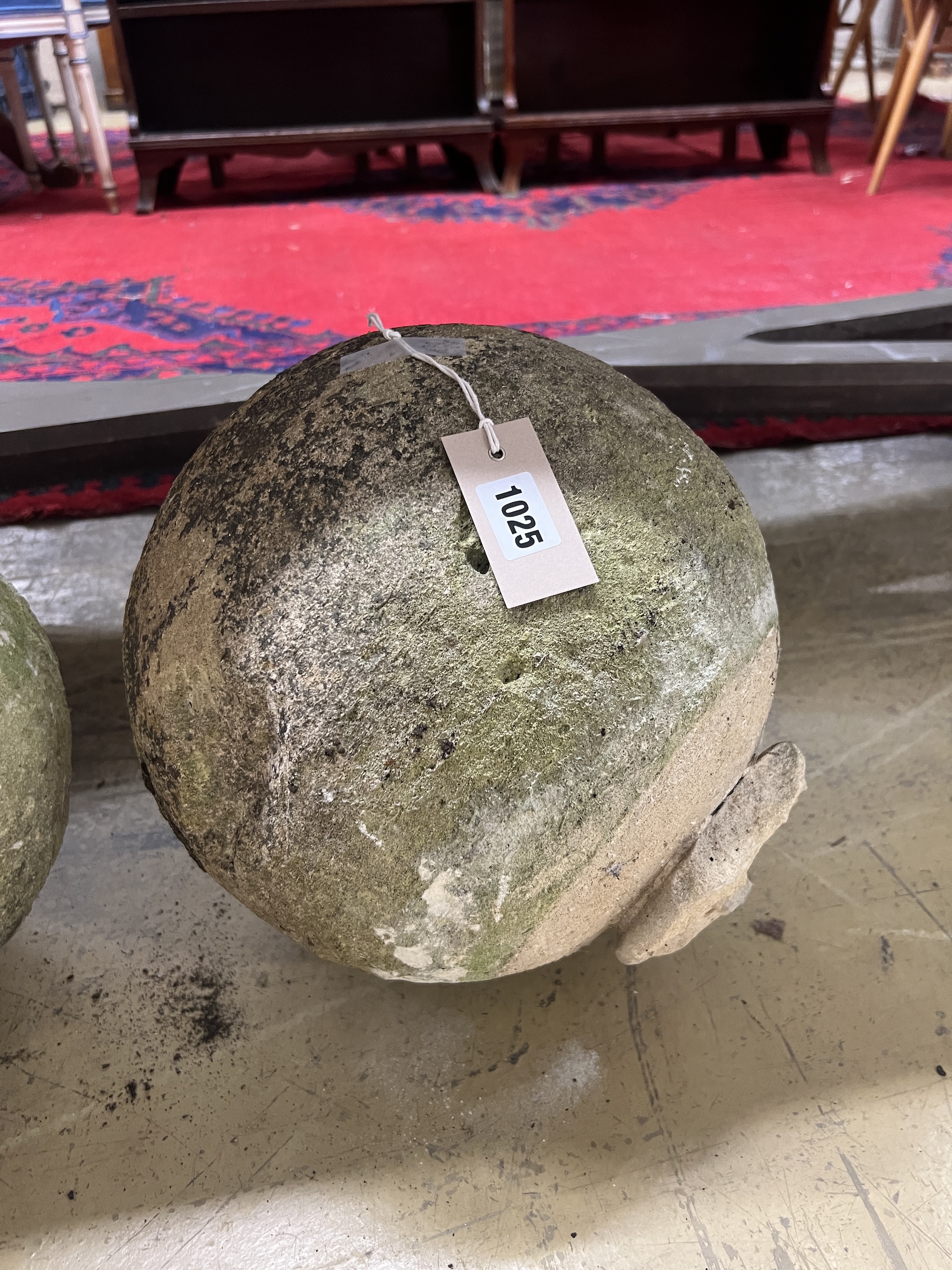 A trio of graduated reconstituted weathered stone ball finials, largest height 37cm